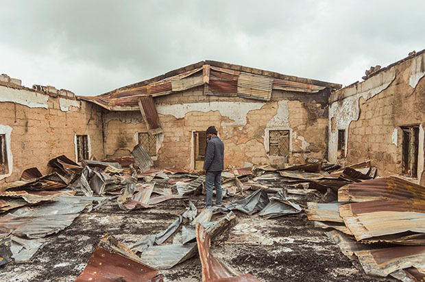 Man standing in destroyed house