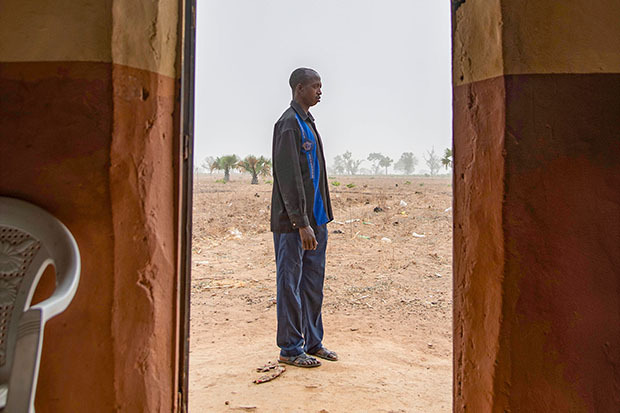 Pastor Emmanuel standing outside
