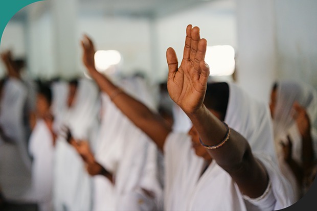 Women praying with their arms raised